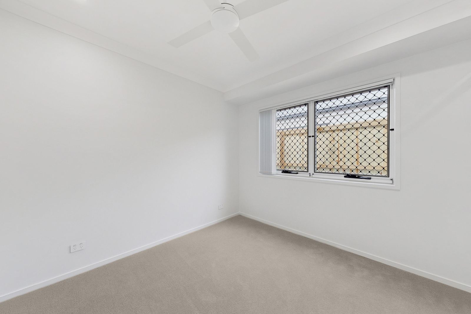Empty bedroom with a single wall window before coastal virtual staging