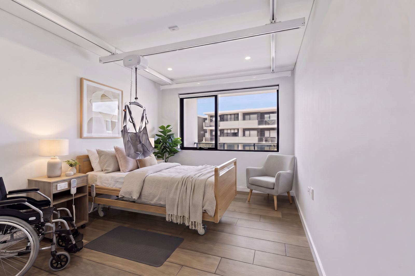 Virtual Staging Services 9 The same bedroom staged for reduced mobility, with an adjustable bed, ceiling hoist and clear wheelchair turning space
