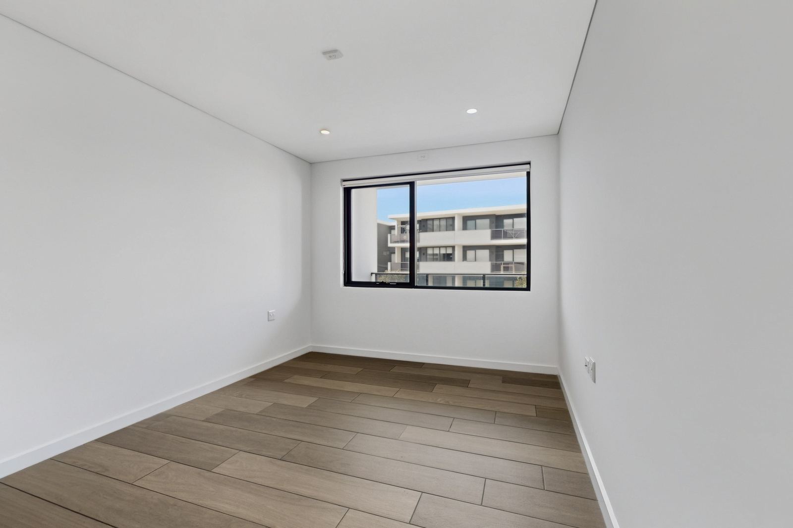 Virtual Staging Before and After 20 Empty bedroom with a timber floor and a single window before accessible virtual staging