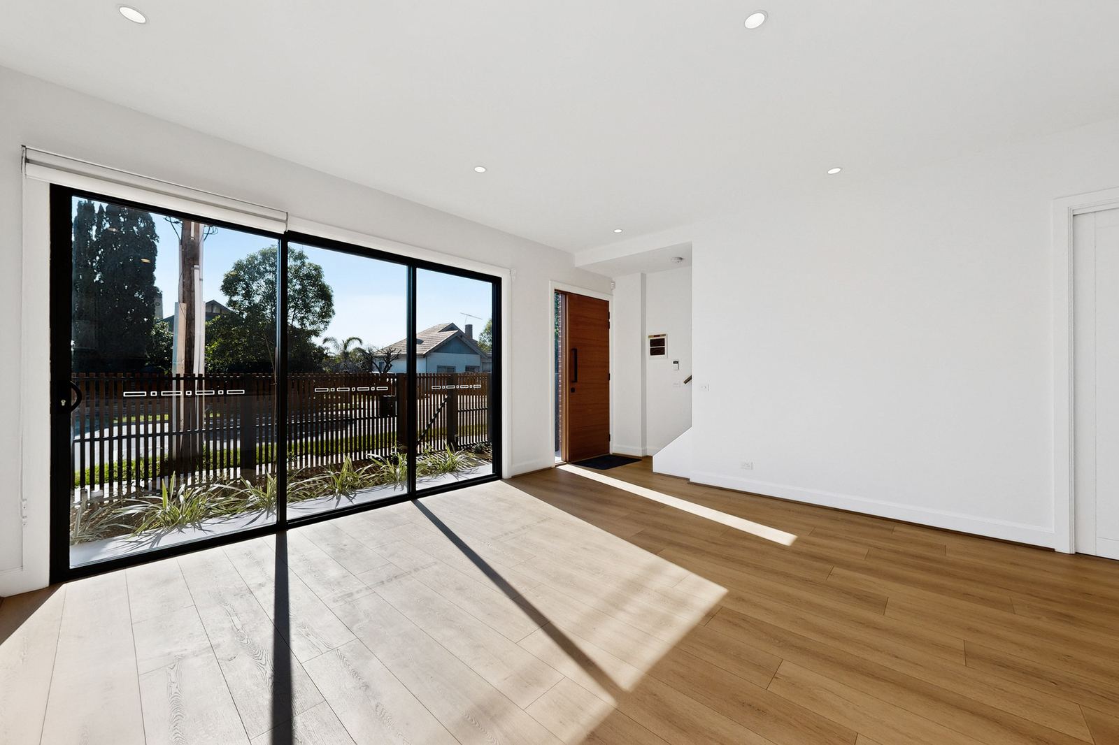 Virtual Staging Before and After 4 Empty open plan living and dining room with timber floors before virtual staging