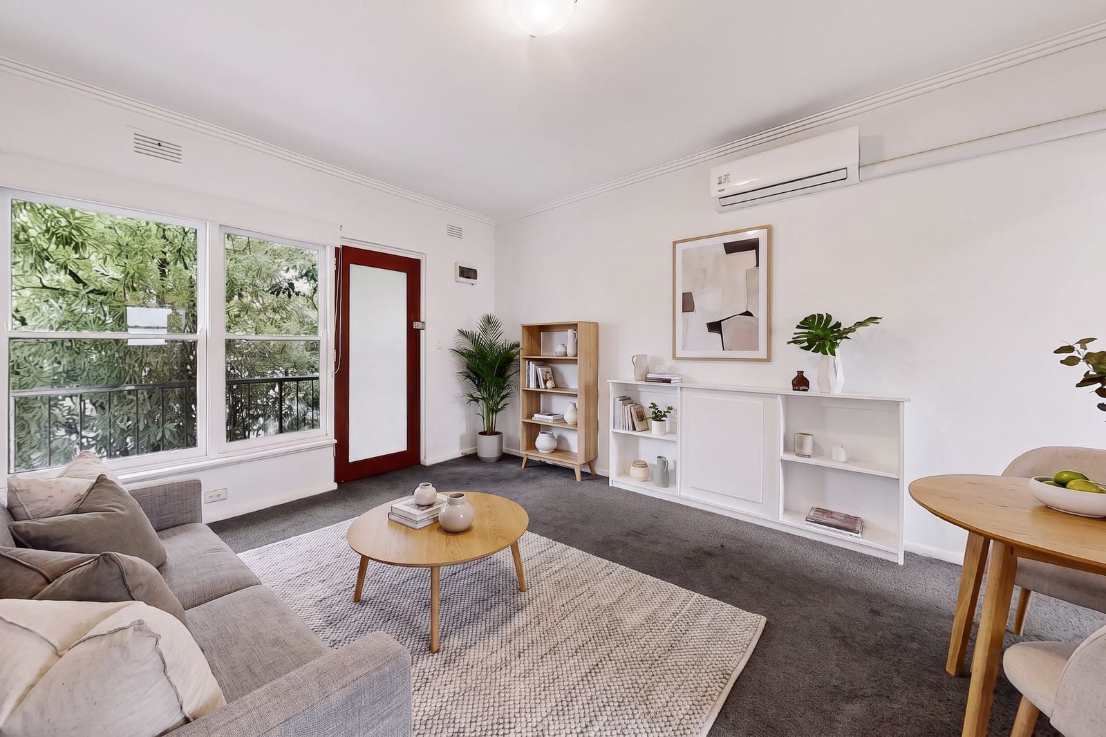 Virtual Staging Service 4 The same virtually staged living room from the opposite corner, with the identical sofa, rug and coffee table