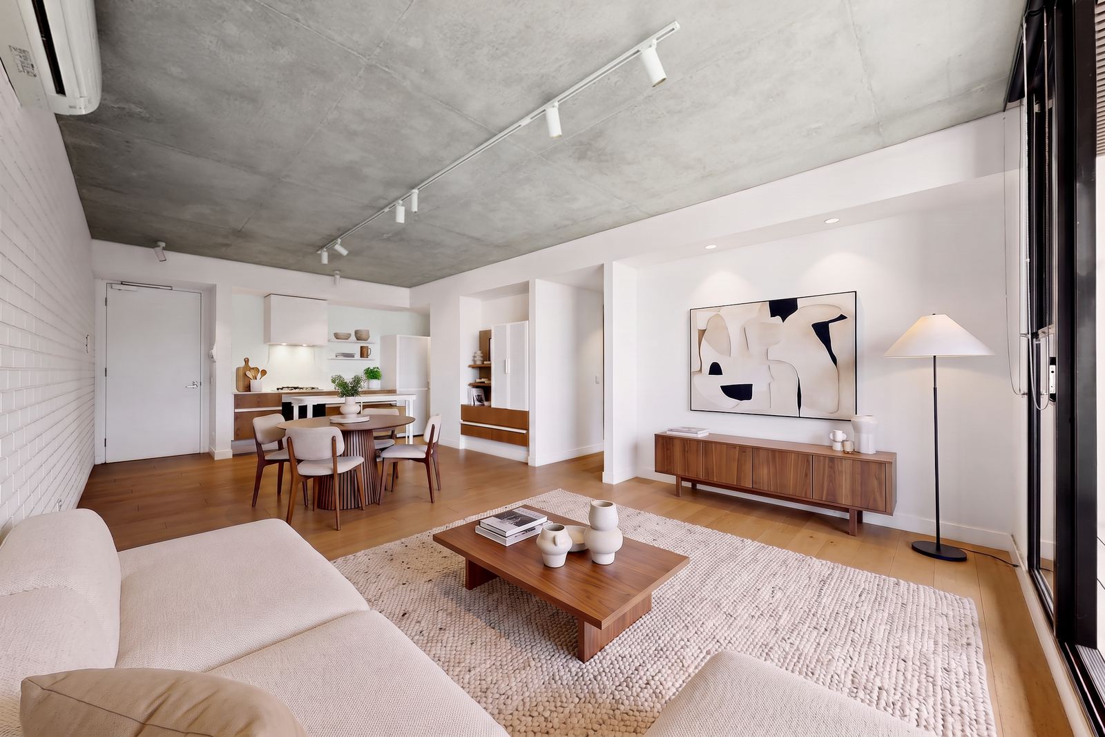About 1 Virtually staged open plan apartment photographed toward the dining zone