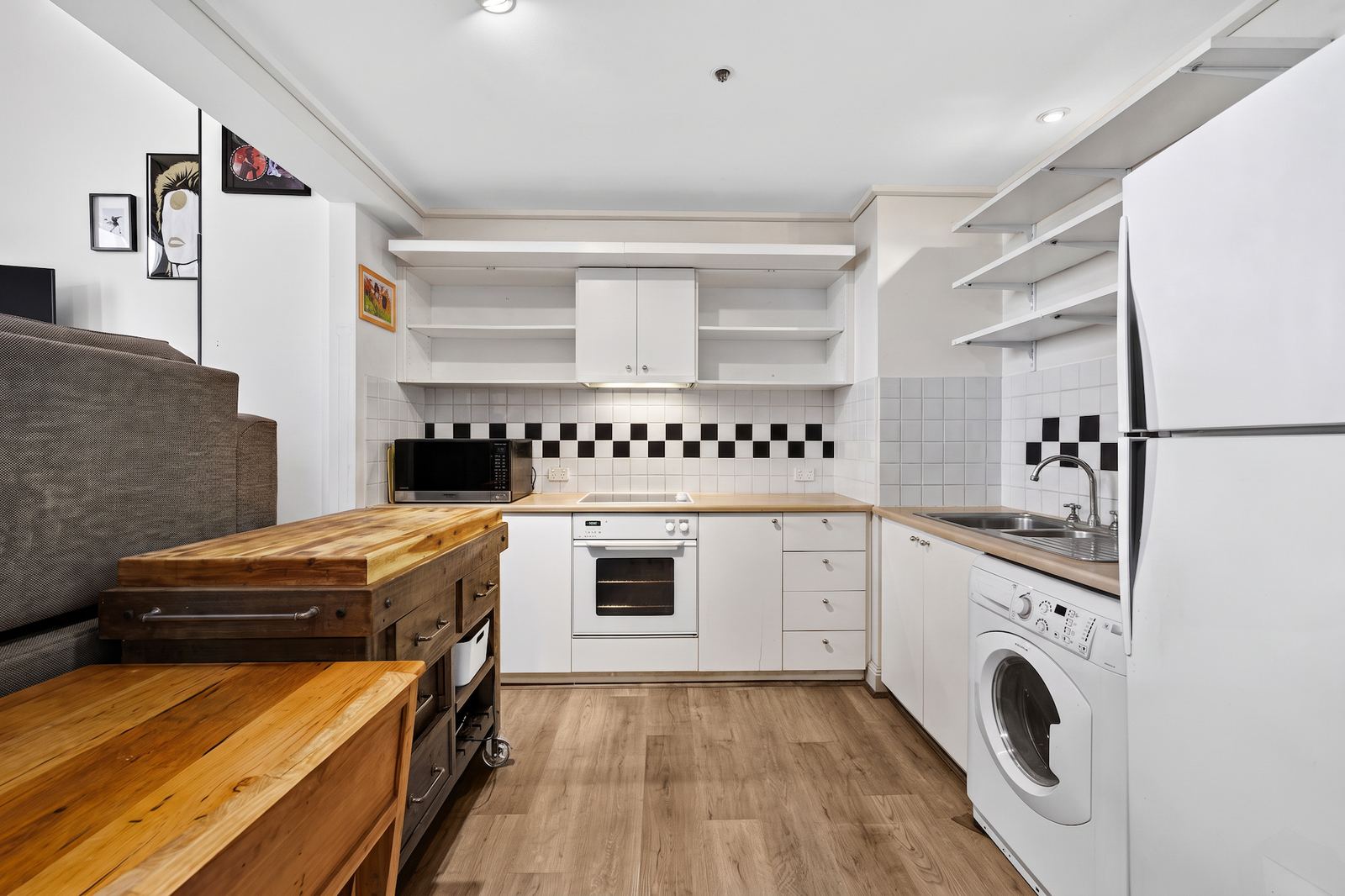 Virtual Staging Services 3 The same kitchen after virtual decluttering, with the shelves and benchtops cleared