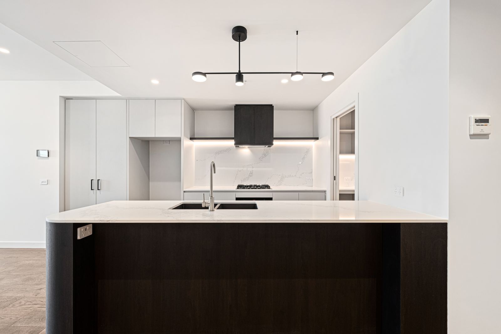 Virtual Staging Services 1 The same kitchen virtually staged with counter styling, bar stools and greenery