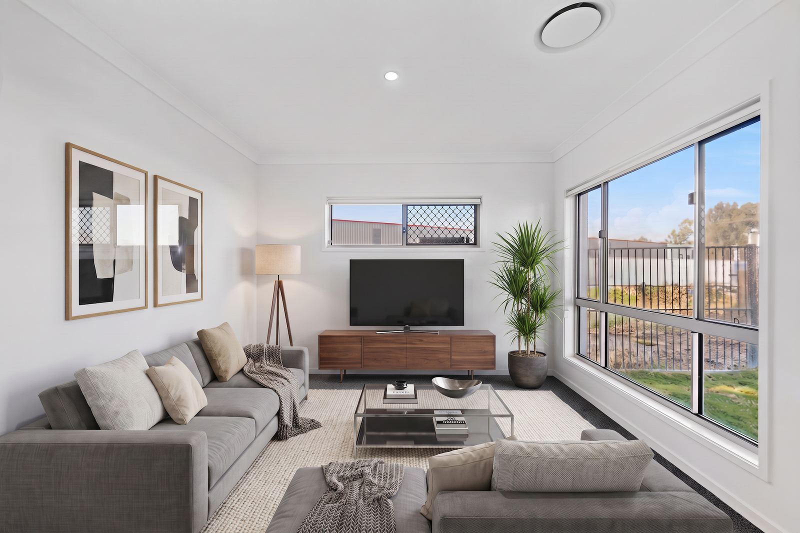Virtual Staging Before and After 1 The same living room after virtual staging, with a sectional sofa, rug and styled shelving