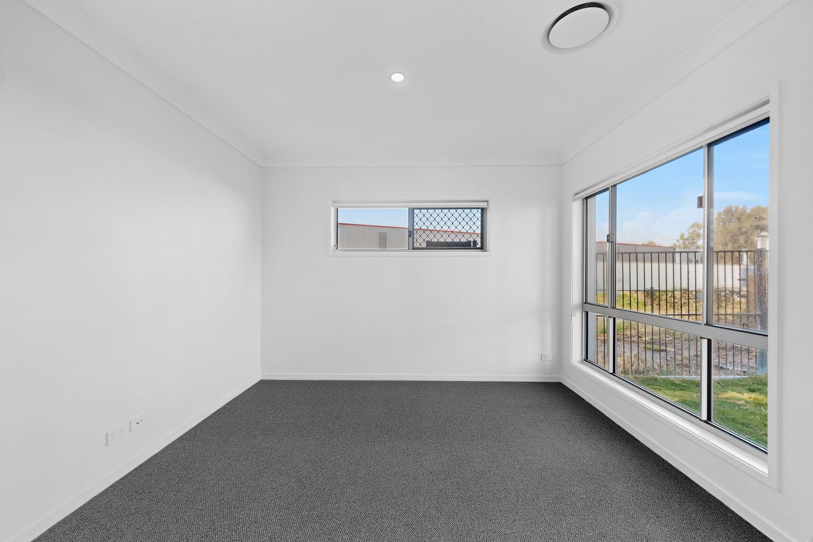 Virtual Staging Before and After 2 Empty living room before virtual staging, with bare carpet and no furniture
